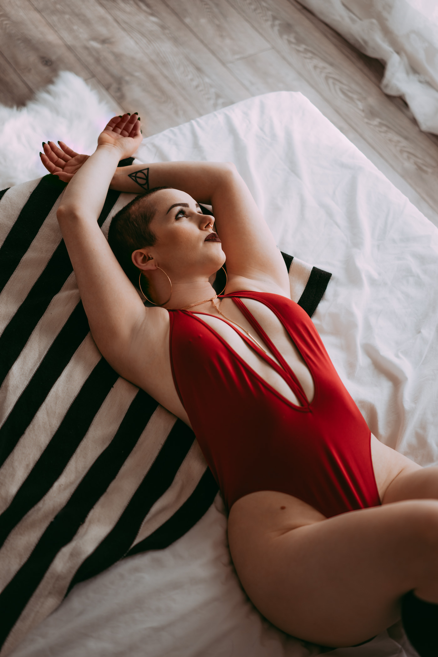 A woman poses for her boudoir photography session at a studio in Edmonton, Alberta, Canada