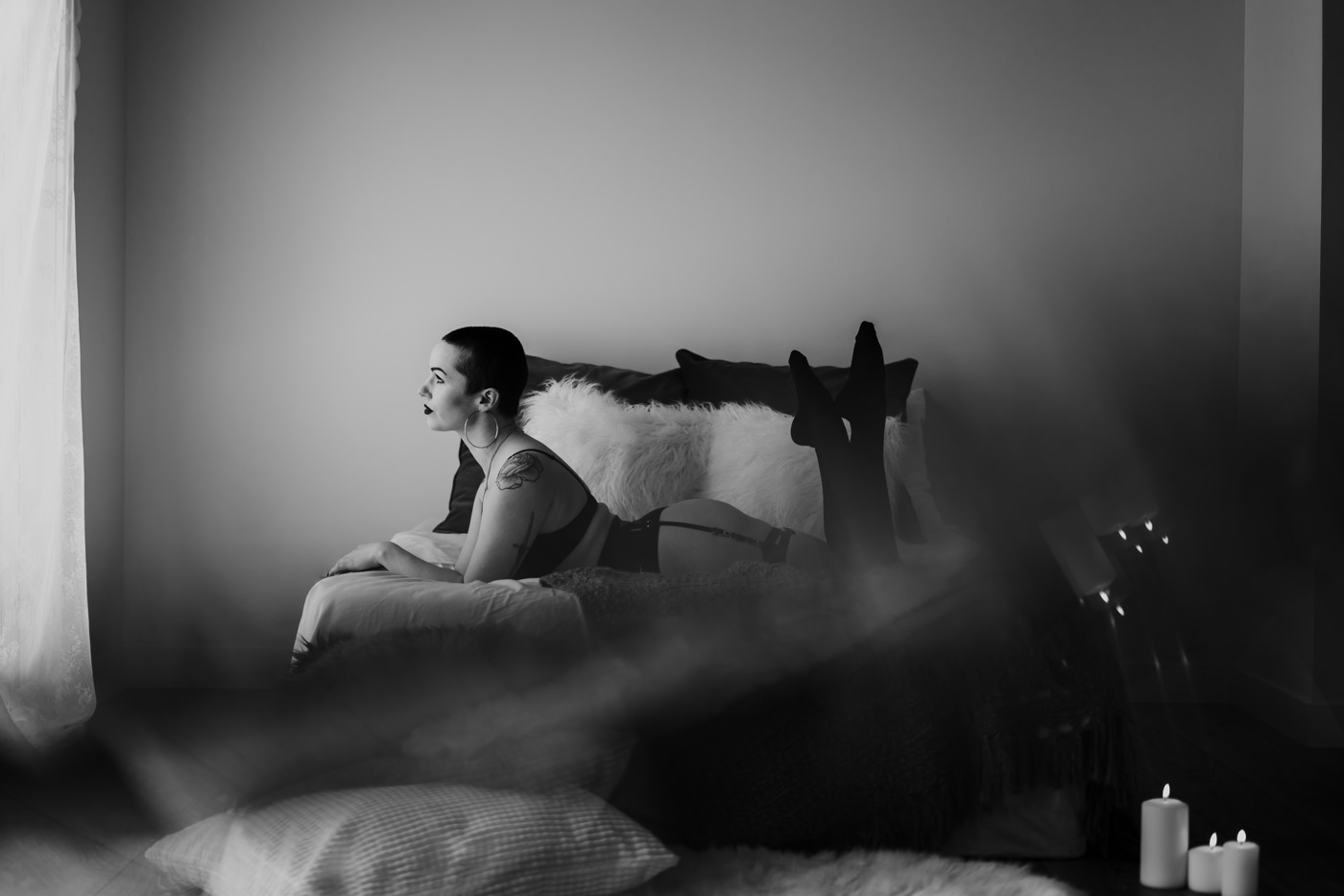 A woman poses for her boudoir photography session at a studio in Edmonton, Alberta, Canada