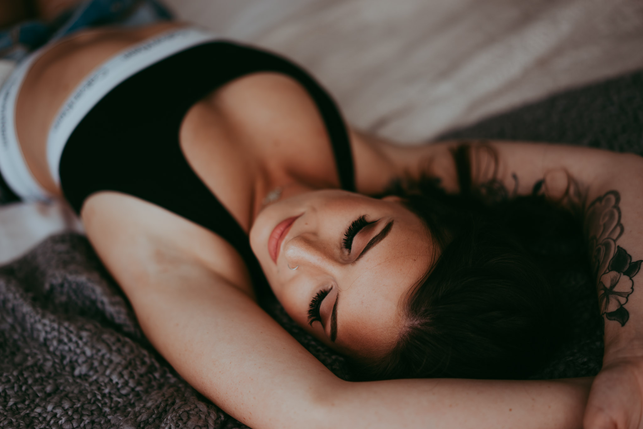 A woman poses for a boudoir photos with Emily Schutz Photography in Edmonton, Alberta, Canada.