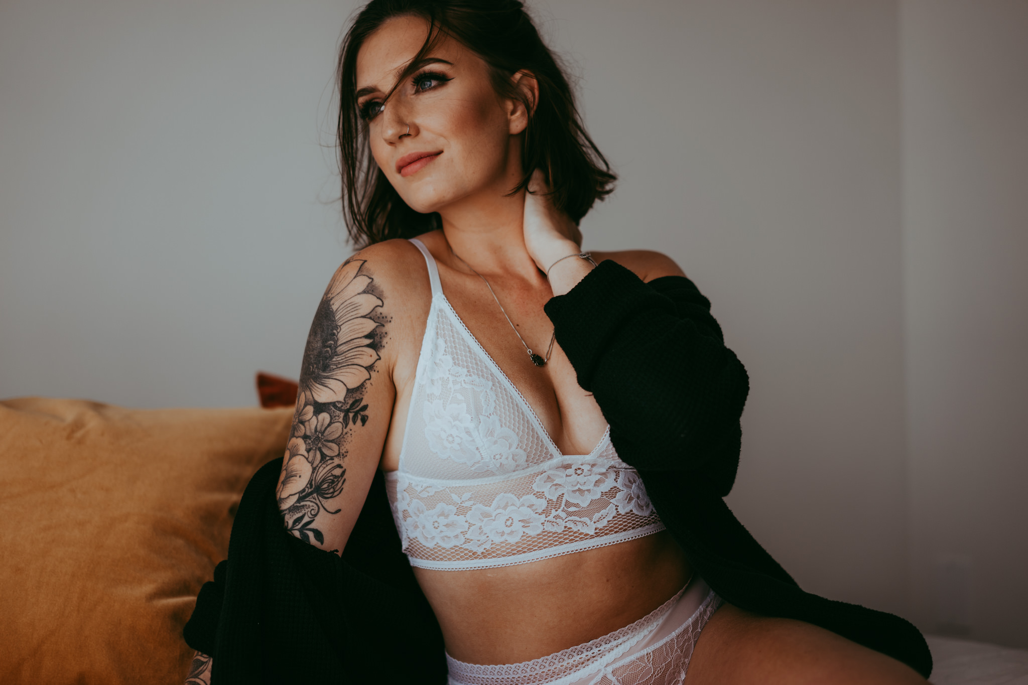 A woman poses for a boudoir photos with Emily Schutz Photography in Edmonton, Alberta, Canada.