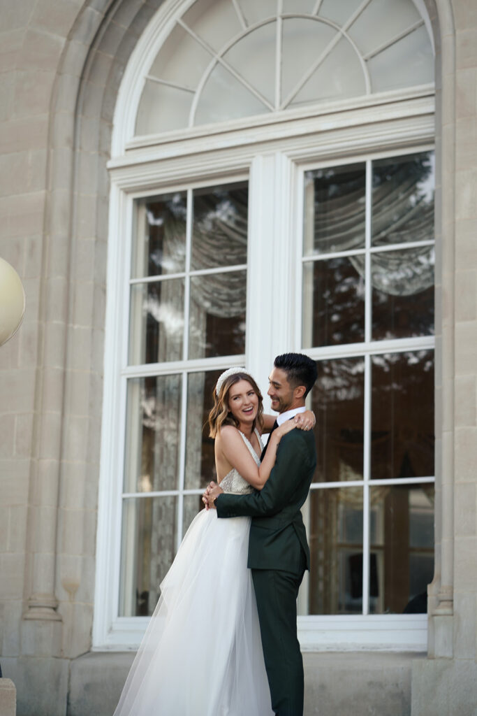 A couple poses for a photo on their wedding day at the Fairmont Hotel Macdonald